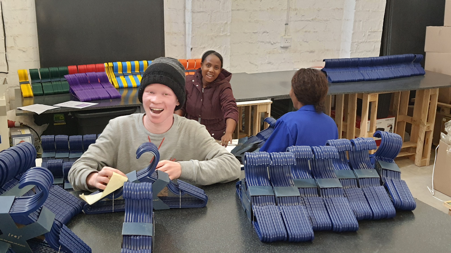 3 South African team members bundling ( r e ) ˣ hangers